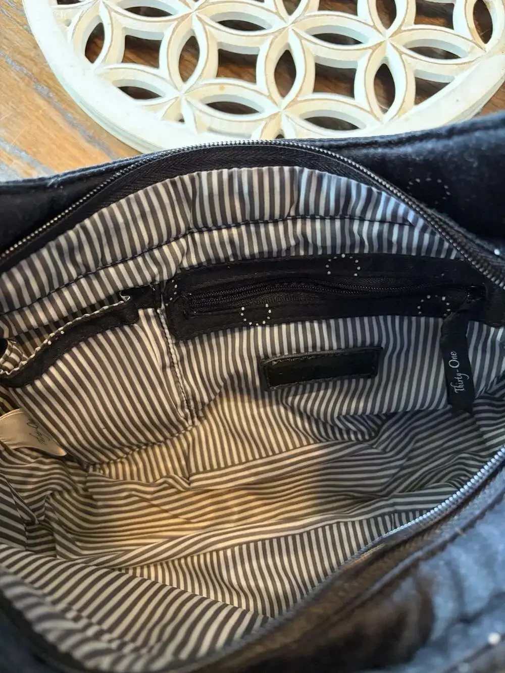 Thirty-One black hobo shoulder bag with white polka dot circles and striped inte